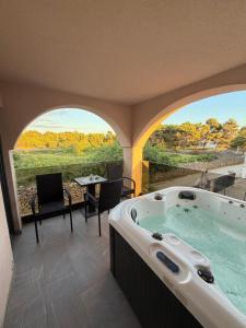 a jacuzzi tub in a room with a view at Villa Asa with private Jacuzzi in Vir