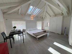 a bedroom with a bed and a table and a desk at Appartamento San Rocco in Intra +22 photos