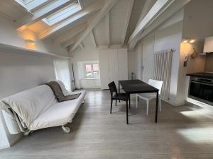 a living room with a table and a couch at Appartamento San Rocco in Intra