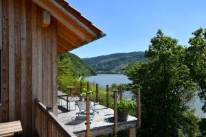 a porch of a cabin with a view of a lake at Danuvius18 in Obernzell
