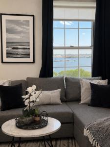 a living room with a couch and a table at Fox Point Landing Residences in Providence