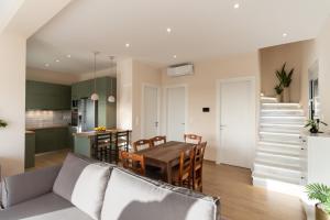 a kitchen and a dining room with a table and chairs at Casa Elaia in Pylos