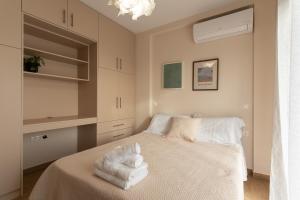 a bedroom with a bed with towels on it at Casa Elaia in Pylos