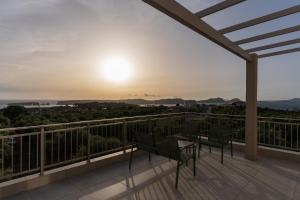 a balcony with a table and chairs at sunset at Casa Elaia in Pylos