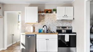 a kitchen with white cabinets and black appliances at West Bench Retreat in Red Lodge