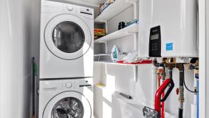a white laundry room with a washer and dryer at West Bench Retreat in Red Lodge +31 photos