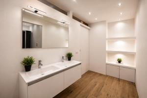 a bathroom with a sink and a mirror at La Galleria Milano - 160 sqm Design Apartment, Spa & Parking in Milan