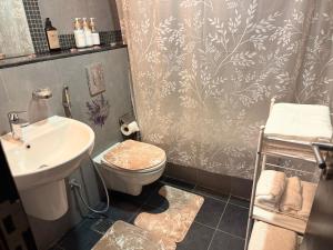 a bathroom with a toilet and a sink at Al Raha Beach modern 1 bedroom near AD airport in Abu Dhabi +9 photos