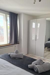 a bedroom with a bed with towels on it at Upstairs Stay Alkmaar in Alkmaar