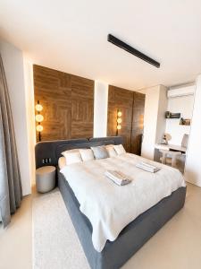 a bedroom with a large bed with a wooden headboard at Eurovea Tower, 27th floor apartment, free parking in Bratislava