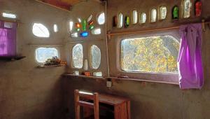 a room with windows and a table in a train at El Cielo in El Bolsón