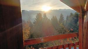 a view of the mountains from a window at El Cielo in El Bolsón