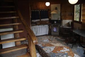 a living room with a staircase and a stove at El Cielo in El Bolsón