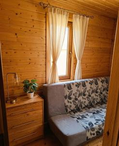 a room with a couch and a window at Miodowe Domki in Władysławowo