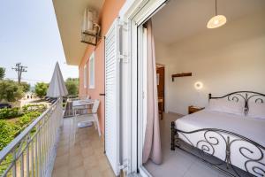 a bedroom with a bed on a balcony at Red Dragon Exclusive accommodation in Dassia