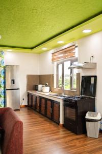 a kitchen with a sink and a stove top oven at Zenith Apartment in Baie du Tombeau