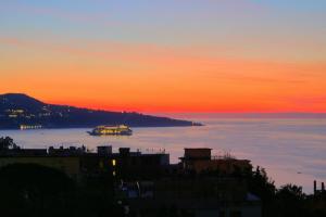 a view of the ocean at sunset at Hotiday Sorrento Capo in Sorrento