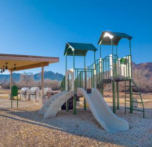 a playground with a slide in a park at EBAC Moab in Moab