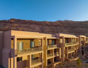 a row of apartment buildings in front of a mountain at EBAC Moab in Moab