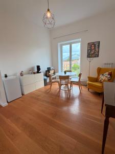 a living room with a table and chairs at Terrazza Vanvitelli in Caserta