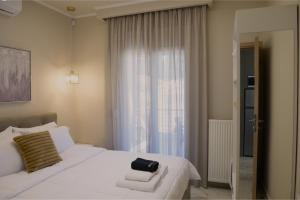 a bedroom with a white bed and a window at Pella Luxury Archonta in Pélla