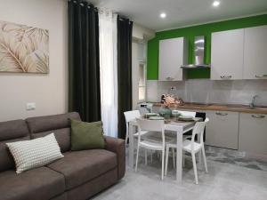 a living room with a couch and a table and a kitchen at Affittacamere CINQUE TERRE LABI in La Spezia
