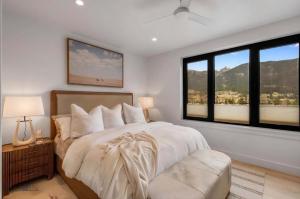 a bedroom with a bed and a large window at Refined Big Sky Luxury Condo in Big Sky