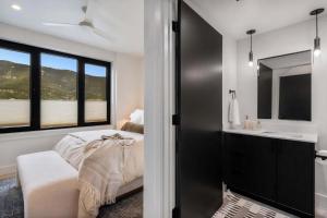 a bedroom with a bed and a sink and a mirror at Refined Big Sky Luxury Condo in Big Sky