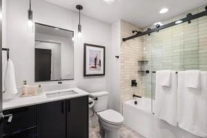 a bathroom with a sink and a toilet and a shower at Refined Big Sky Luxury Condo in Big Sky +1 photo