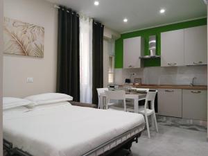 a bedroom with two beds and a table and a kitchen at Affittacamere CINQUE TERRE LABI in La Spezia +61 photos