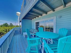 a deck with tables and chairs on a house at Sandcastle Townhomes #24 in Navarre +41 photos