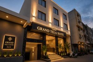 a facade of a hotel with a sign that reads grand taza suite at Hotel Grand Tela Suite Delhi in Gurgaon