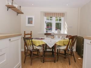 a dining room with a table and chairs at Upper Frogpool Cottage in Crediton +43 photos