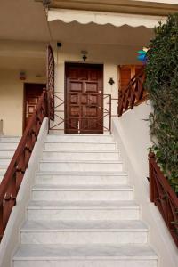 a set of stairs leading to the door of a house at Two-floor house next to sea in Loutraki