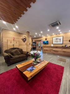 ein Wohnzimmer mit Sofa und Tisch in der Unterkunft Hotel Pucón Indómito in Pucón