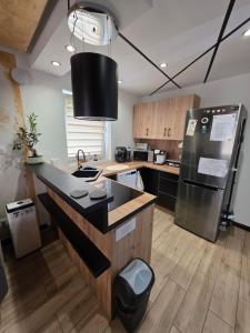 a kitchen with a counter top and a refrigerator at Rose in Bielawa