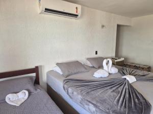 a bedroom with two beds with towels on them at Luxury Oceanfront House - Beachfront - Pool in Aquiraz +35 photos