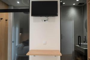 a flat screen tv on a wall in a room at Ceramic Rooms Boutique Hostel in Villareal