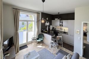 a living room with a kitchen and a dining room at Ferienwohnung Truding in Stralsund
