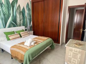a bedroom with a bed with a towel on it at AljaLux Sevilla Bormujos in Bormujos