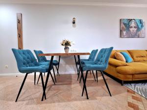 a living room with a table and a couch at Marina Forest in Sozopol