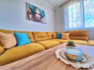 a living room with a yellow couch and a table at Marina Forest in Sozopol