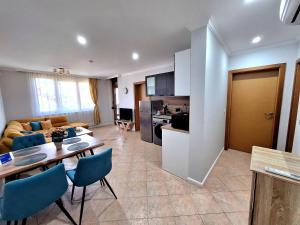 a kitchen and a living room with a table and chairs at Marina Forest in Sozopol +26 photos