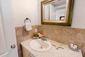 a bathroom with a sink and a mirror at KC28 Fantastic Fifth Street in Key Colony Beach +34 photos