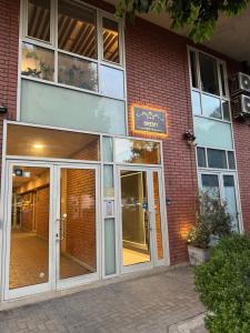 an entrance to a brick building with a glass door at Hotel Oresti Center in Tirana