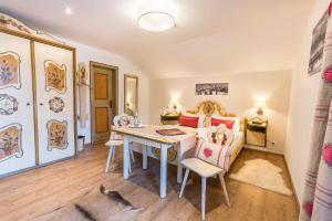 a living room with a table and a cat on the floor at Gasthof Alter Wirt in Bernau am Chiemsee +13 photos
