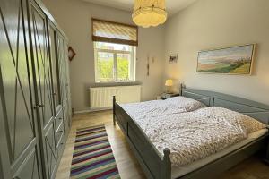 a bedroom with a bed and a window at Ferienwohnung Truding in Stralsund