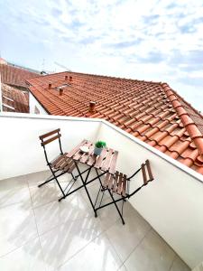 two chairs on a balcony with a roof at Loft City Center Viana in Viana do Castelo