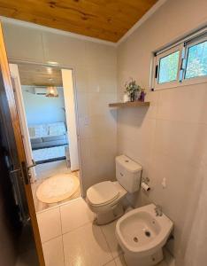 a bathroom with a toilet and a sink at Casa de campo ElChale cerca del autodromo de Rafaela in Rafaela