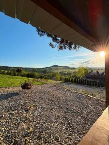 a view from a porch of a house with the sun shining at Sowie wzgórze in Krynica Zdrój